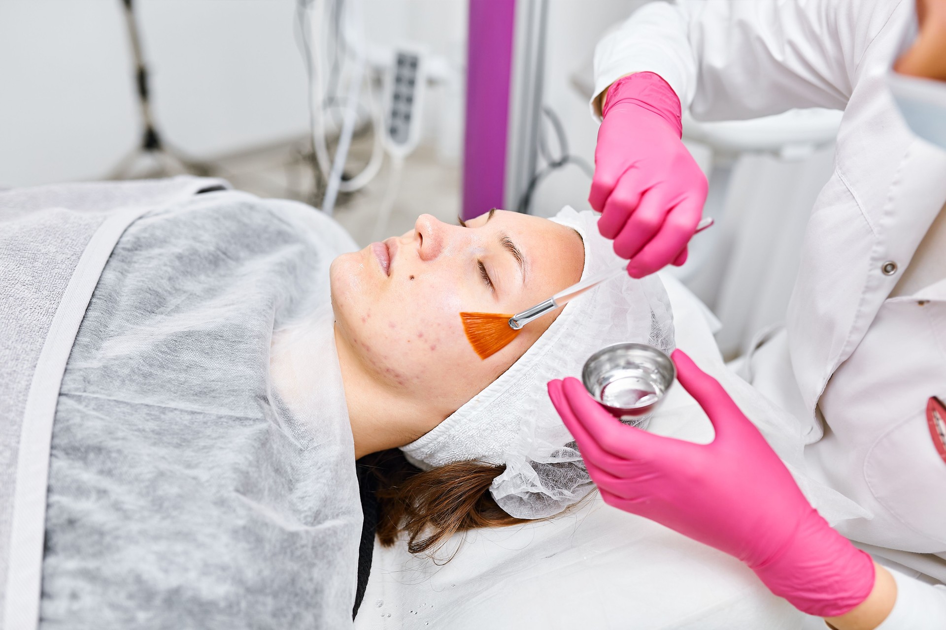 Portrait Cosmetologist applying mask on client's face in spa salon. Wellness center. Healthcare occupation